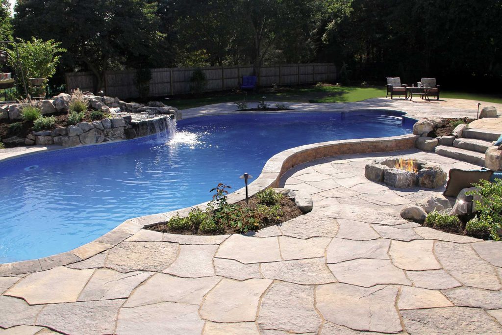 Grand Flagstone uses varied forms and natural texture to give this Nicolock patio an organic character that flows comfortably into the surrounding landscape.