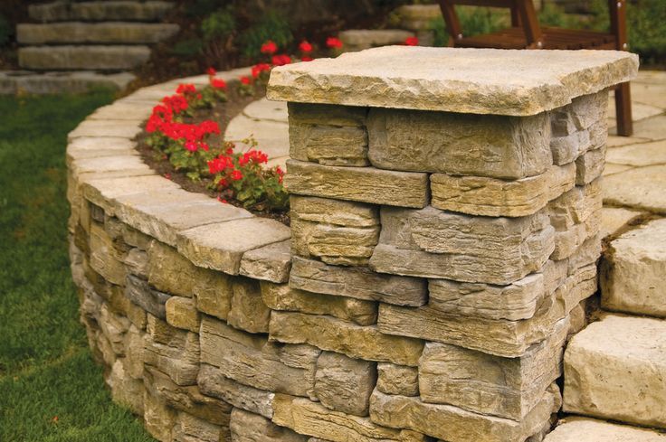 Smooth beige stone wall coping topping a brick wall with mortar joints, designed to protect and finish the wall edge.